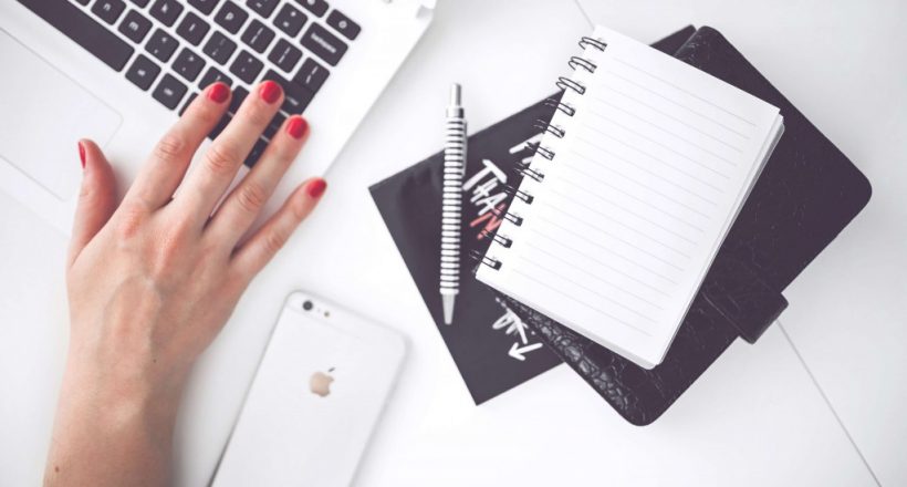 woman-hand-smartphone-desk